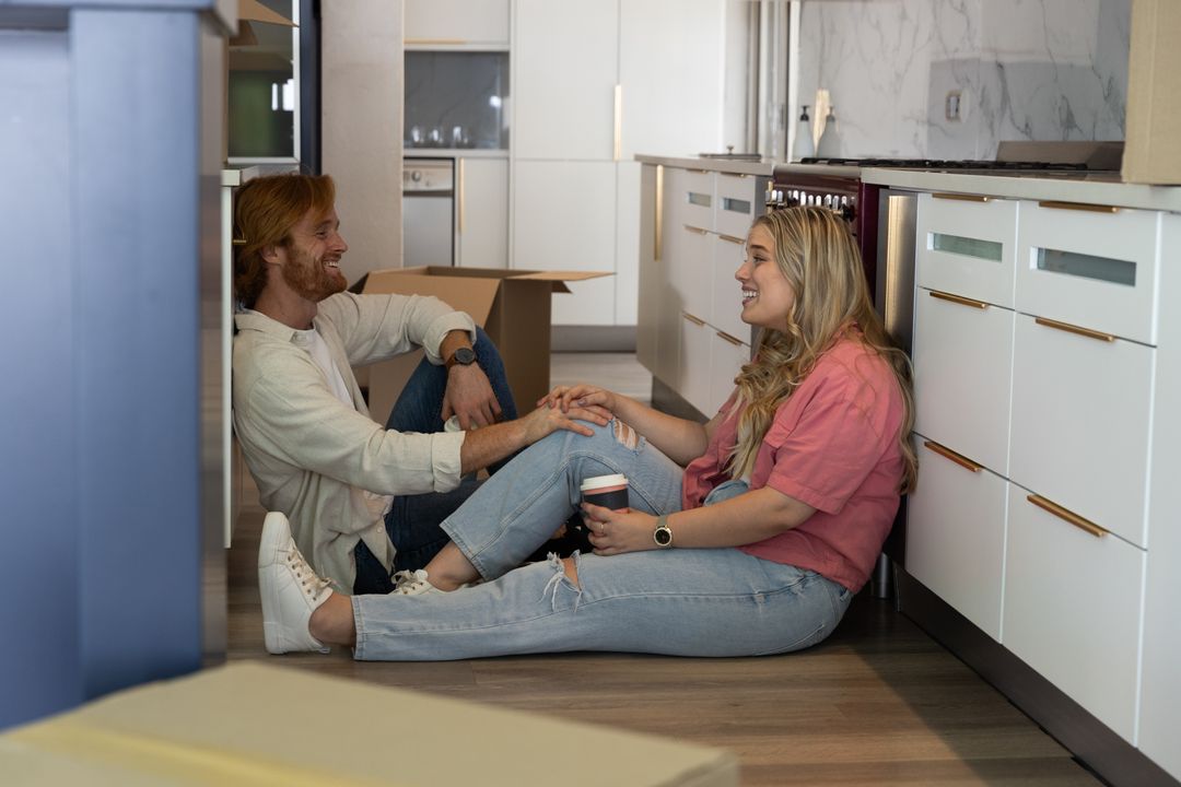 Couple Enjoying Coffee Break Amidst Moving Boxes