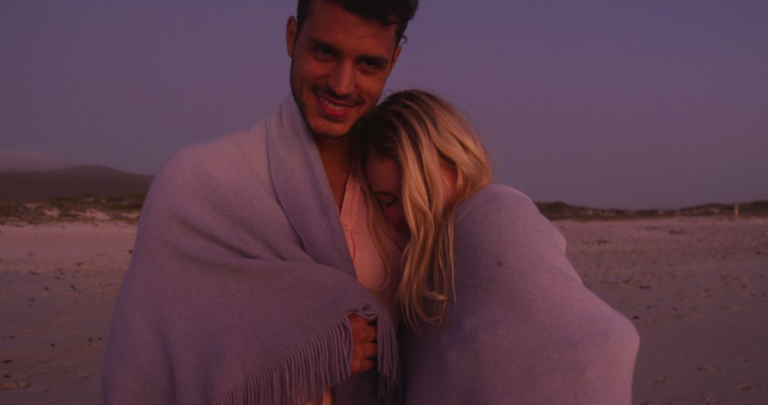 Romantic Couple Wrapped in Blanket During Sunset on Beach - Free Images, Stock Photos and Pictures on Pikwizard.com