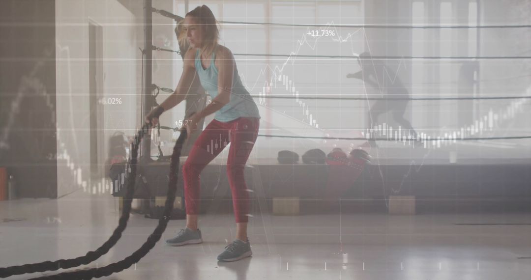 Woman Swinging Battle Ropes with Financial Chart Overlay in Gym