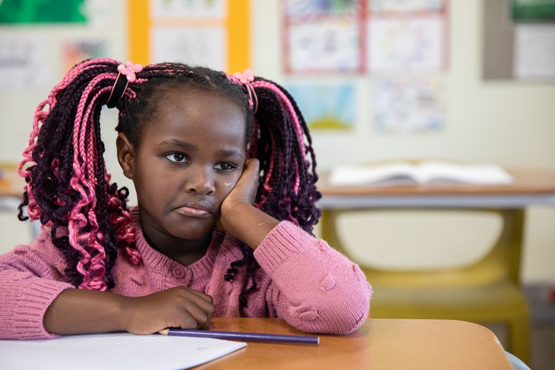 Young Student in Classroom Posing Thoughtfully