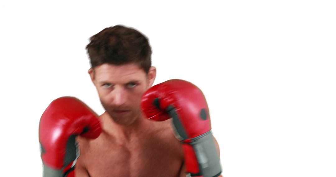 Focused Man Wearing Red Boxing Gloves in Motion - Free Images, Stock Photos and Pictures on Pikwizard.com