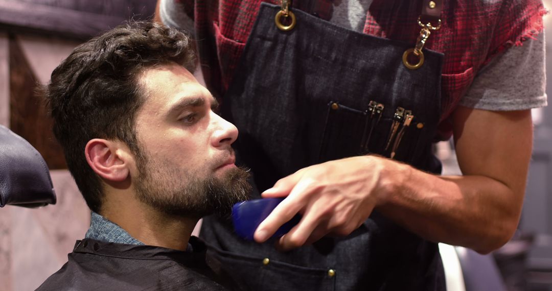 Man undergoing precision beard trimming in modern barber shop - Free Images, Stock Photos and Pictures on Pikwizard.com