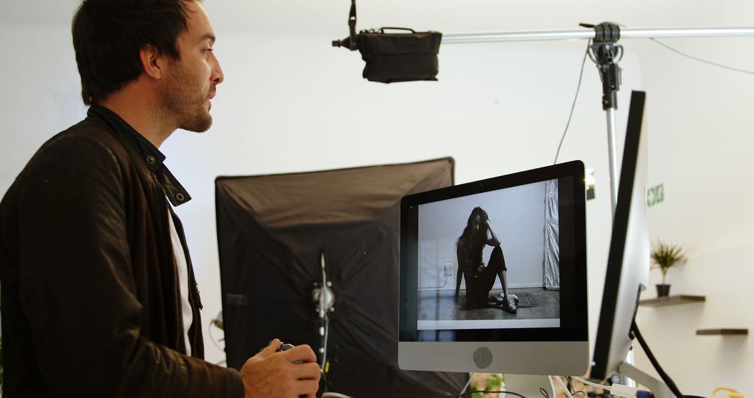 Photographer Reviewing Black and White Portrait on Computer Screen in Studio - Free Images, Stock Photos and Pictures on Pikwizard.com