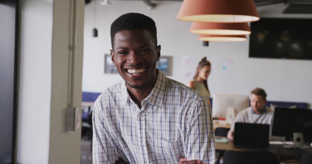Smiling Businessman Exudes Confidence in Modern Office Environment
