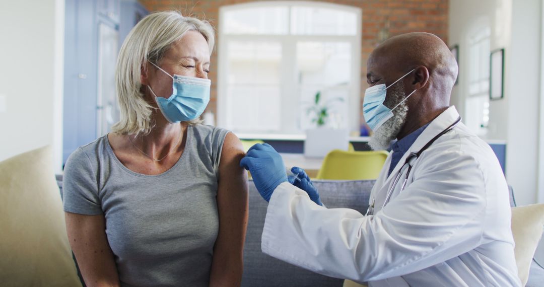 Doctor Administering Vaccine Shot to Woman in Modern Clinic - Free Images, Stock Photos and Pictures on Pikwizard.com