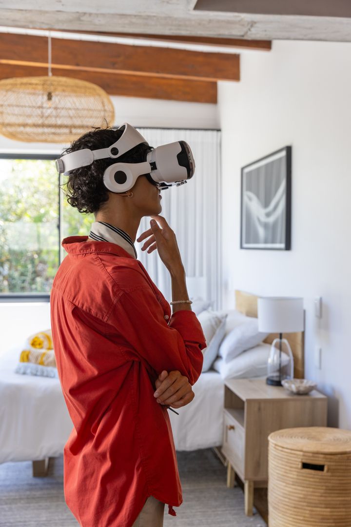 Man Engaging with Virtual Reality Headset in Modern Bedroom
