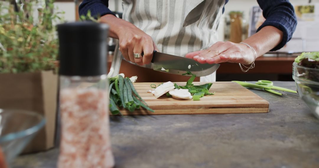 Person Chopping Vegetables on Wooden Cutting Board - Free Images, Stock Photos and Pictures on Pikwizard.com