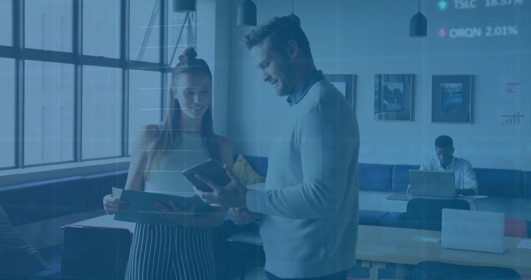 Caucasian Colleagues Discussing Technology in Modern Office