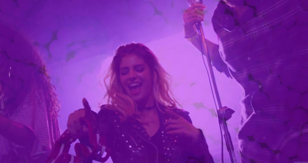 Energetic Performer Waving Ribbons On Stage During Concert