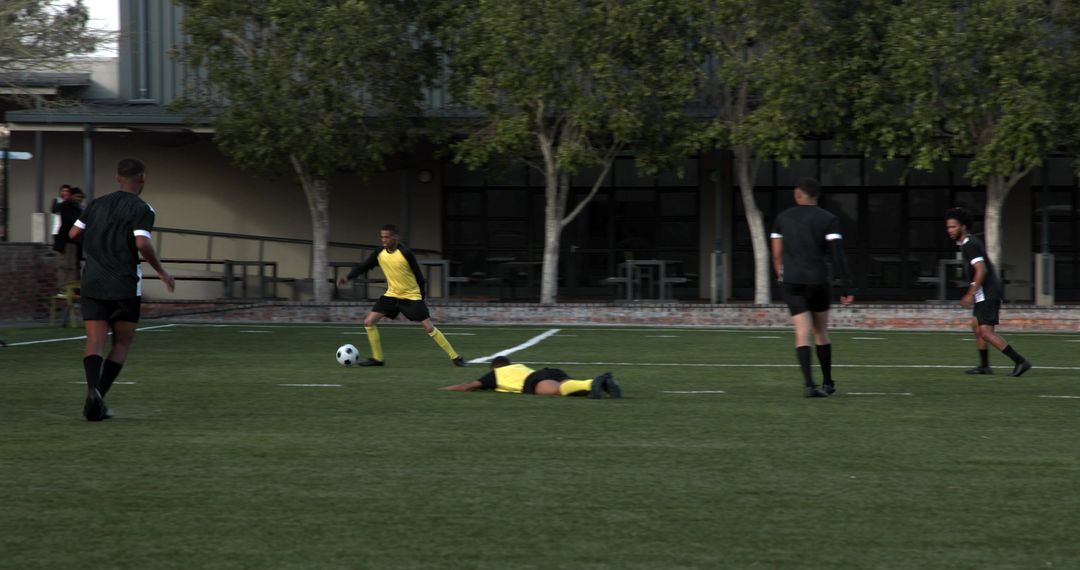 Group of Boys Playing Soccer on School Field in Action