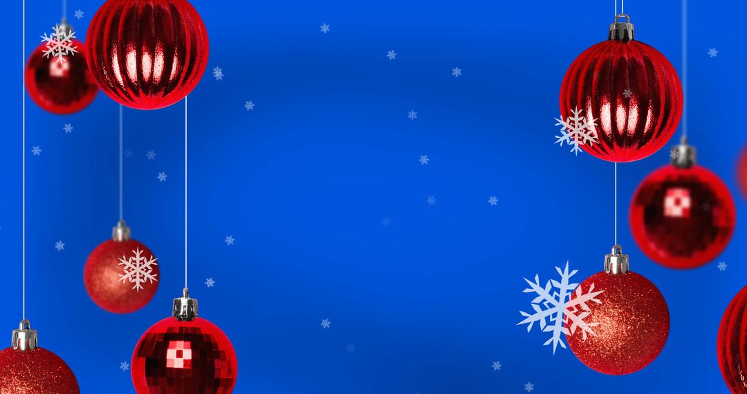 Red Christmas Baubles and Falling Snowflakes on Blue Background