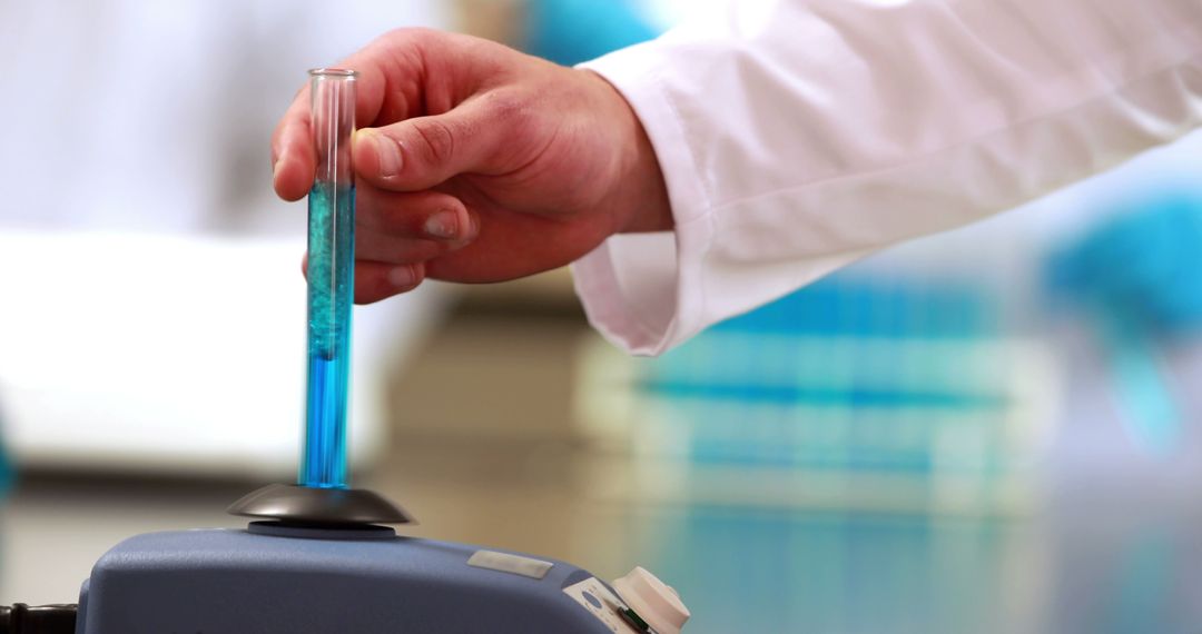 Scientist Using Laboratory Mixer with Test Tube - Free Images, Stock Photos and Pictures on Pikwizard.com