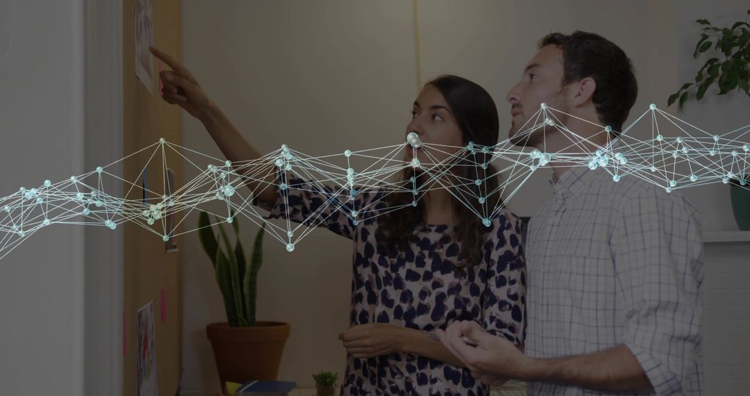 Two Professionals Analyzing Notice Board with Network Graphics