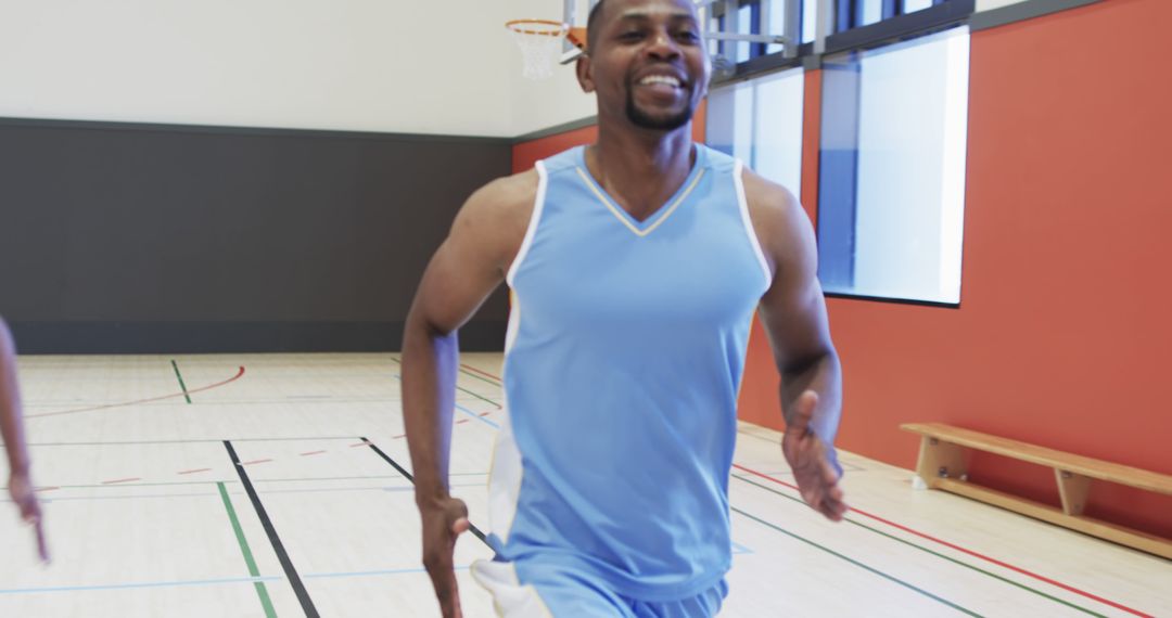 Smiling Basketball Player Running During Practice in Gym - Free Images, Stock Photos and Pictures on Pikwizard.com