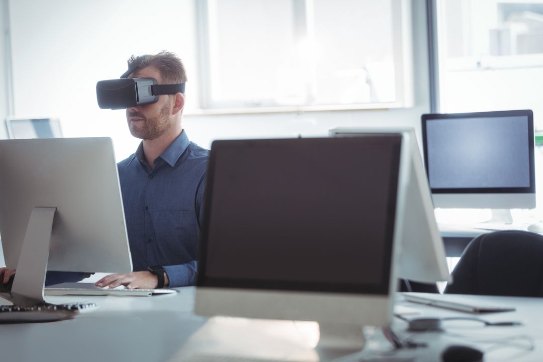 Focused Man Experiencing Virtual Reality in Modern Office Setup