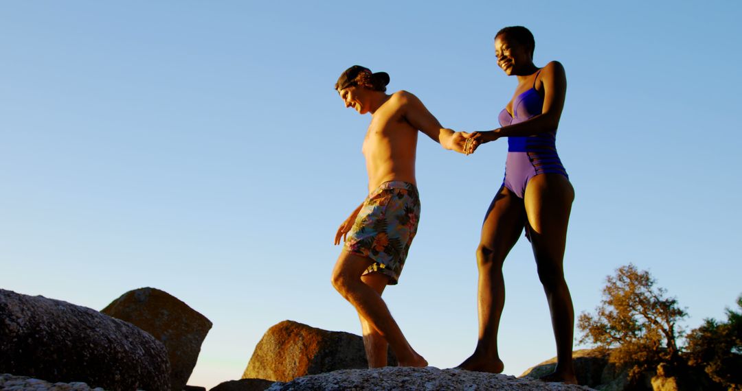 Couple Enjoying a Summer Day on Rocky Beach - Free Images, Stock Photos and Pictures on Pikwizard.com