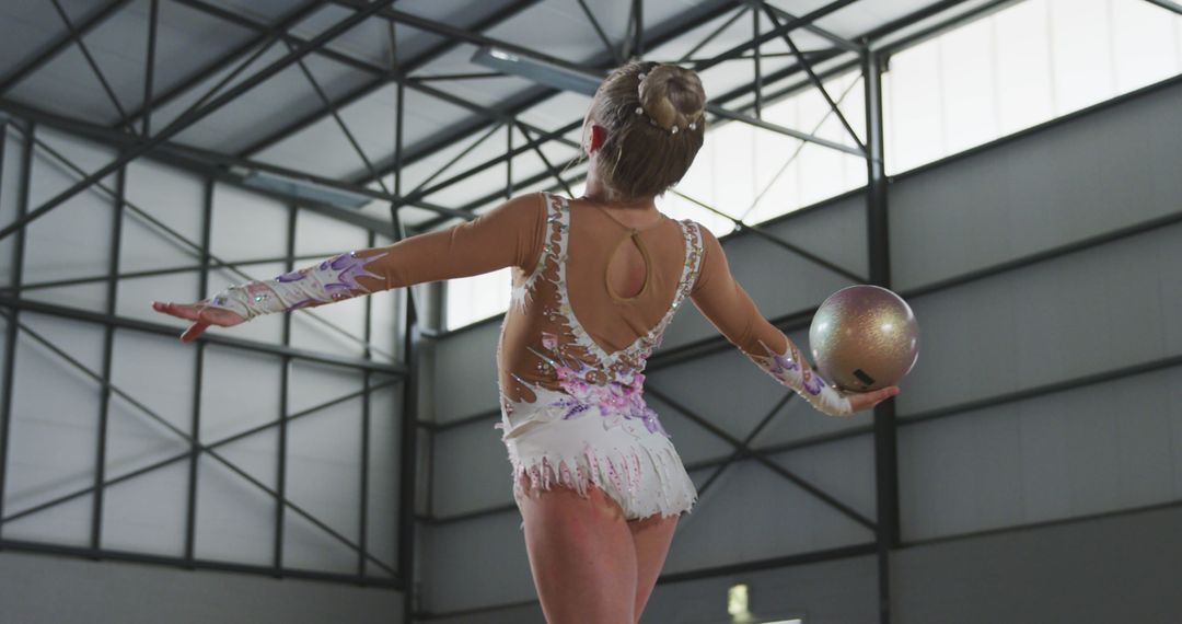 Female Rhythmic Gymnast Performing with Ball in Sports Hall - Free Images, Stock Photos and Pictures on Pikwizard.com