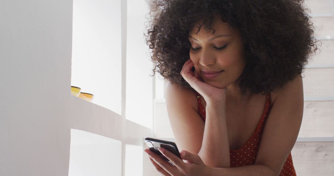 Happy Woman at Home Messaging on Smartphone with Smile