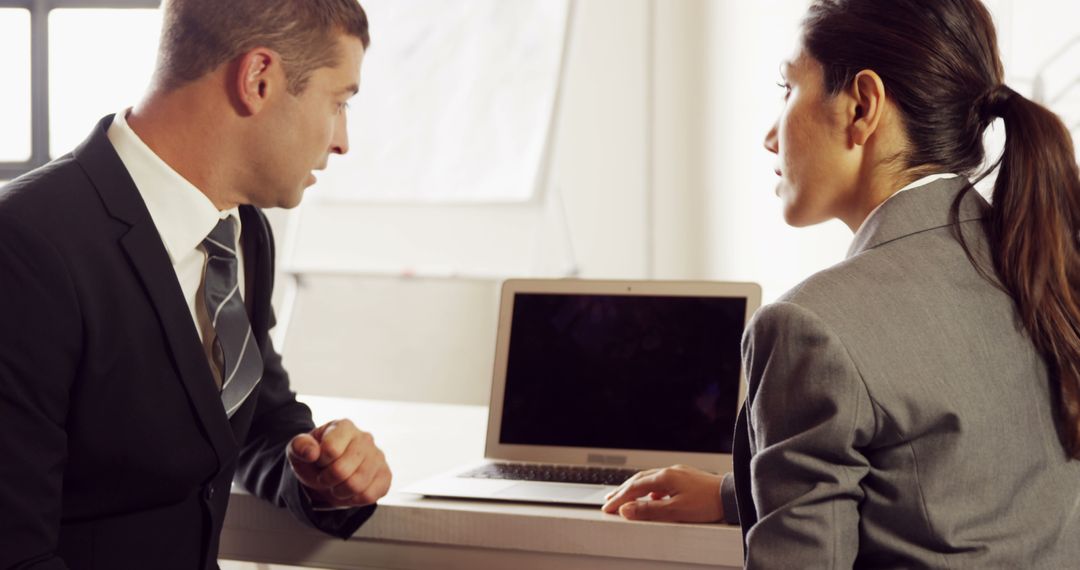 Business professionals collaborating on a laptop in office - Free Images, Stock Photos and Pictures on Pikwizard.com