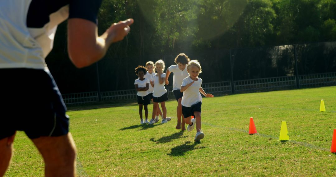 Children Engaging in Outdoor Fitness Game with Coach Persently Guide - Free Images, Stock Photos and Pictures on Pikwizard.com