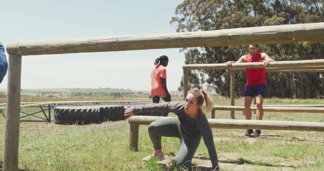 Fit Group Navigating Outdoor Obstacle Course in Sunlight