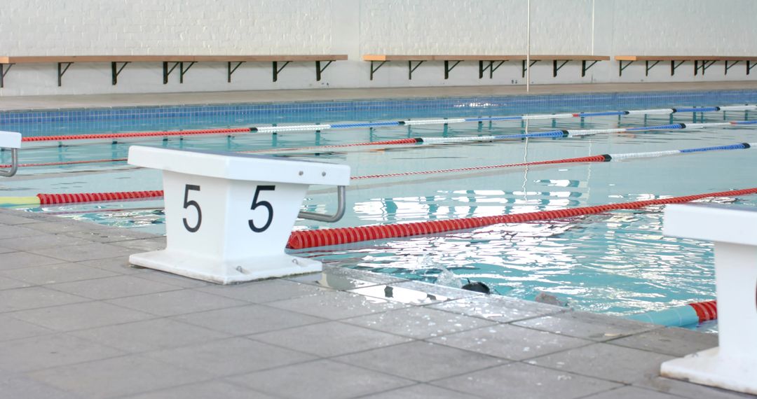 Indoor Olympic Pool Starting Block Number 5 on Tiled Deck with Lane Dividers