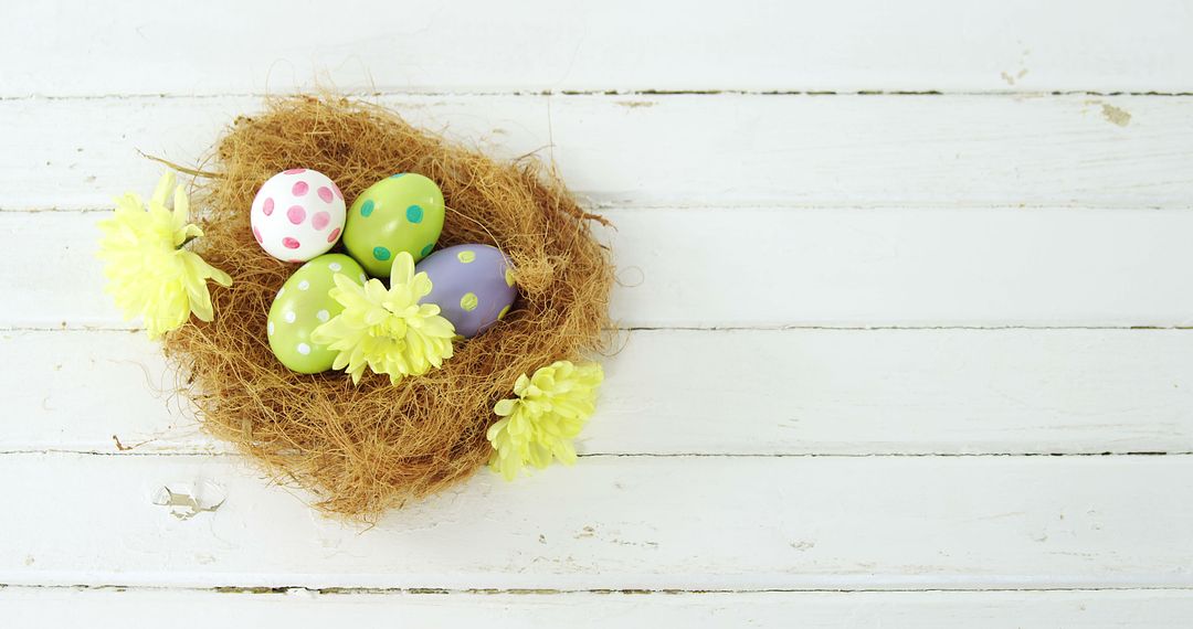 A vibrant Easter egg nest with yellow flowers celebrates spring on a white backdrop. - Free Images, Stock Photos and Pictures on Pikwizard.com