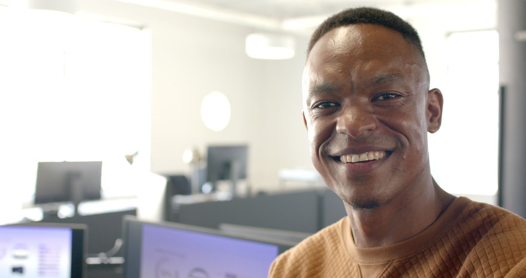 Smiling Professional Man in Modern Office Workspace