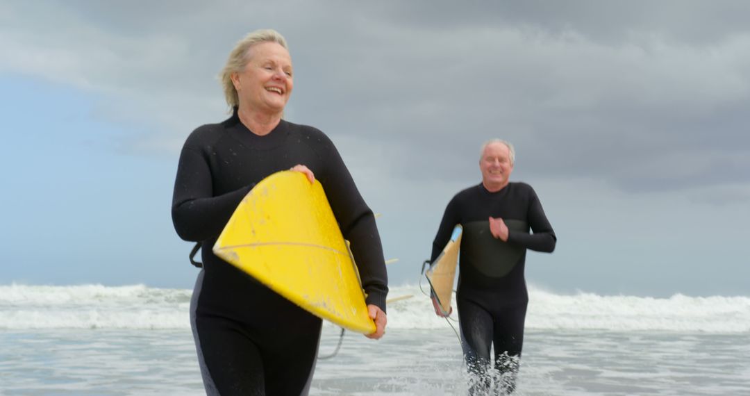 Senior Couple Enjoying Surfing on a Cloudy Day - Free Images, Stock Photos and Pictures on Pikwizard.com