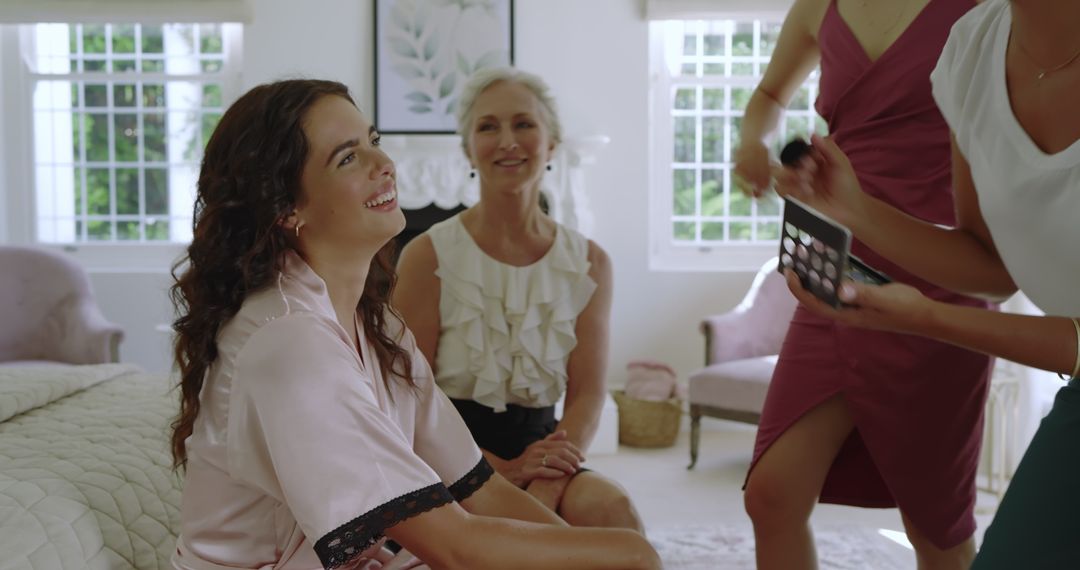 Bride Smiling During Makeup Session with Supportive Bridesmaid