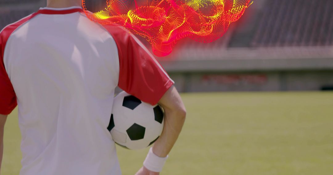 Soccer Player Holding Ball at Stadium Wearing Red Jersey and Wristband with Dynamic Energy