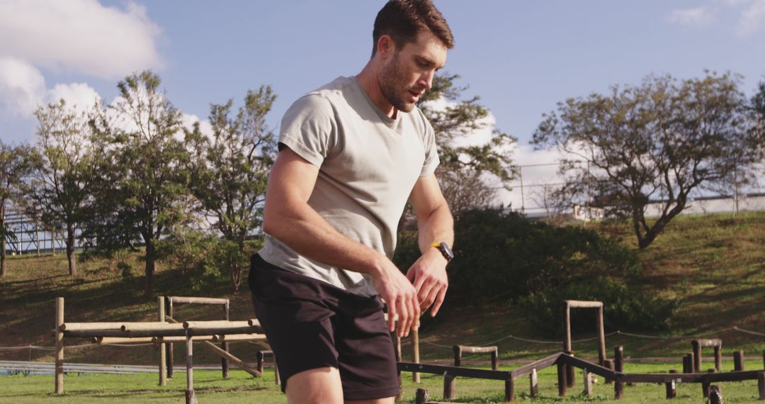 Man Wearing Smartwatch on Outdoor Obstacle Course - Free Images, Stock Photos and Pictures on Pikwizard.com