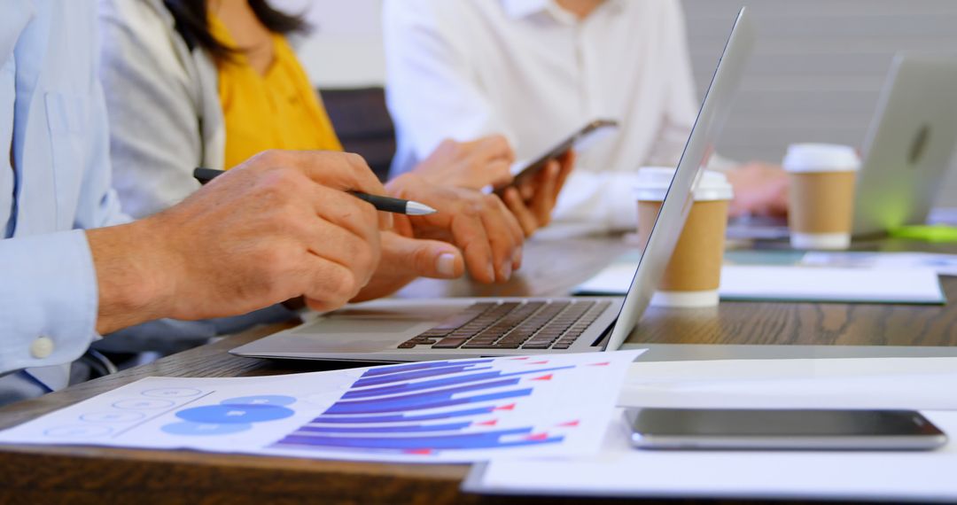 Business Professionals Analyzing Data in Collaborative Meeting