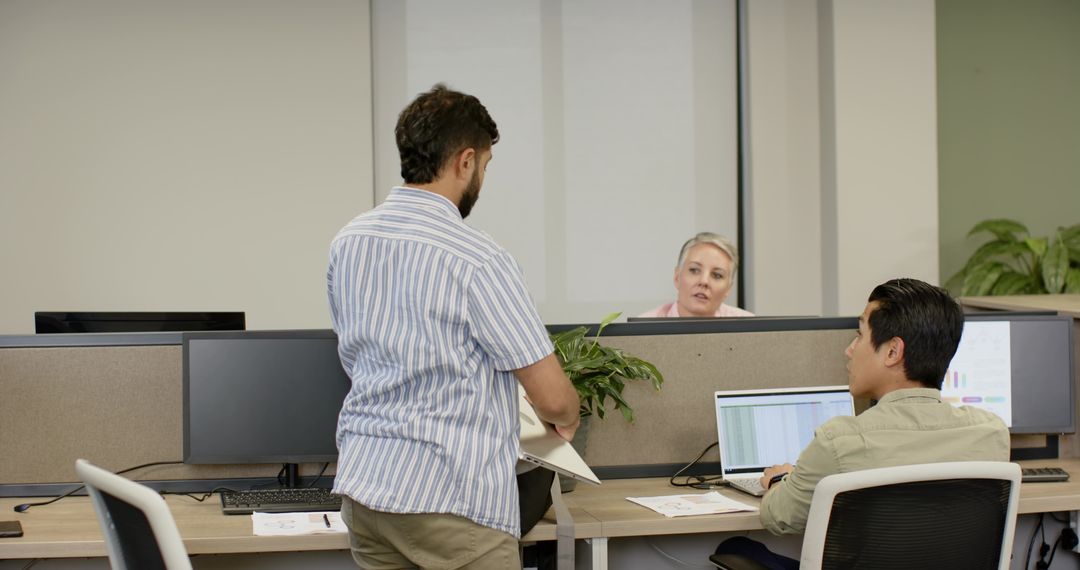 Colleagues Collaborating at Modern Office Workstation