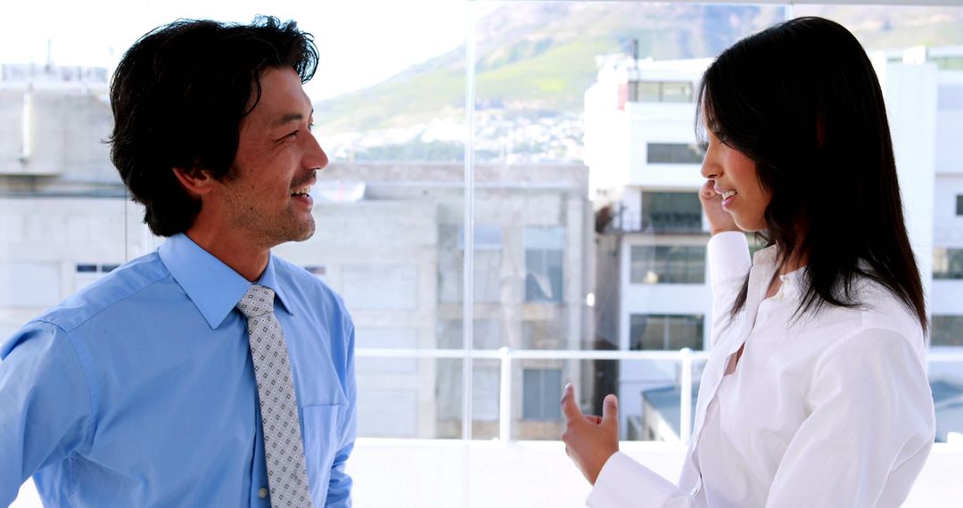 Business Colleagues Smiling and Conversing in Office Setting