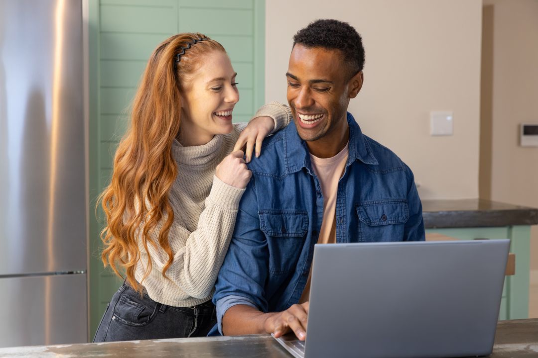 Diverse Couple Enjoying Technology in Modern Kitchen