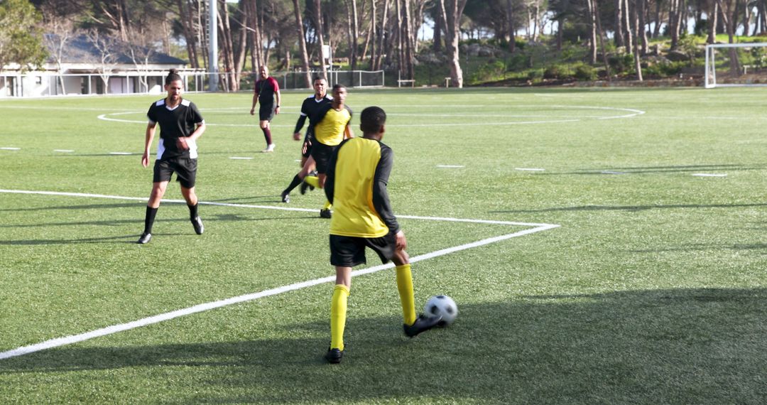 Soccer Players Practicing Teamwork and Strategy on Field
