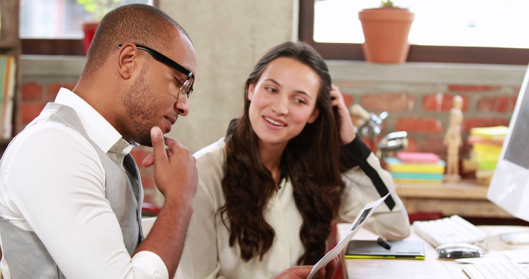 Collaborative Office Team Discussing Projects in Modern Workspace