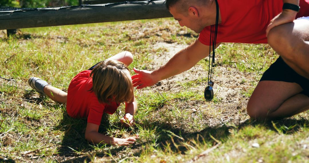 Young Boy Overcoming Outdoor Obstacle Course with Coach Support - Free Images, Stock Photos and Pictures on Pikwizard.com