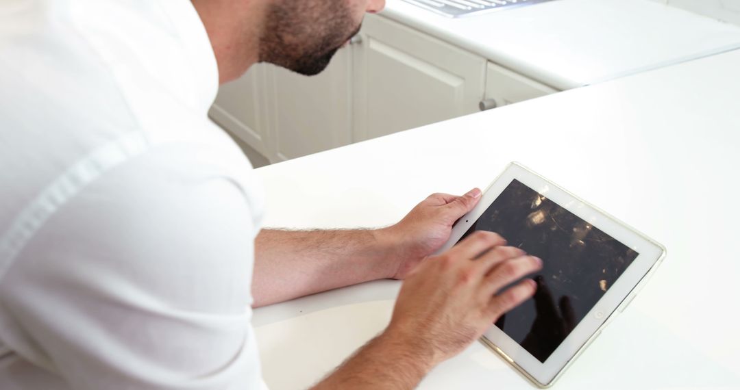 Man Using Digital Tablet in Kitchen While Standing - Free Images, Stock Photos and Pictures on Pikwizard.com