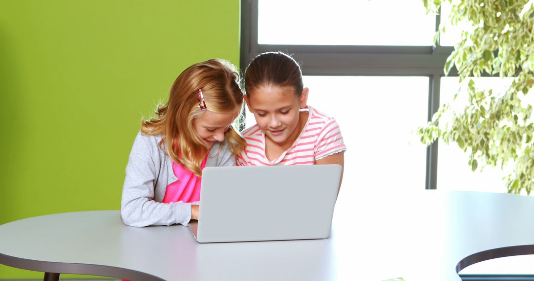 Two Young Girls Using Laptop at Bright Modern Classroom - Free Images, Stock Photos and Pictures on Pikwizard.com