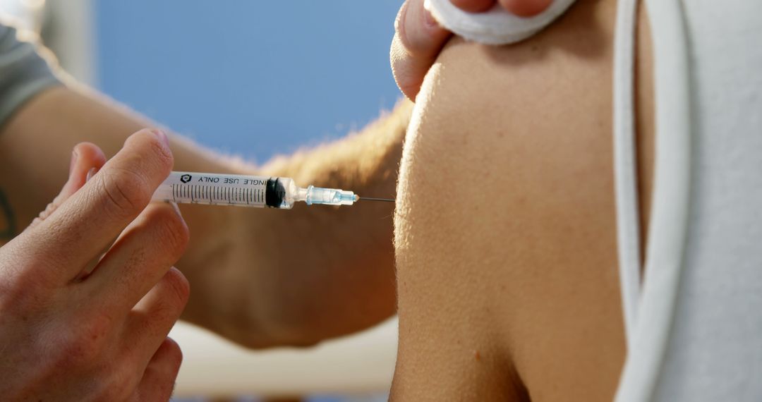 A healthcare professional is administering a vaccine to a patient, with copy space - Free Images, Stock Photos and Pictures on Pikwizard.com