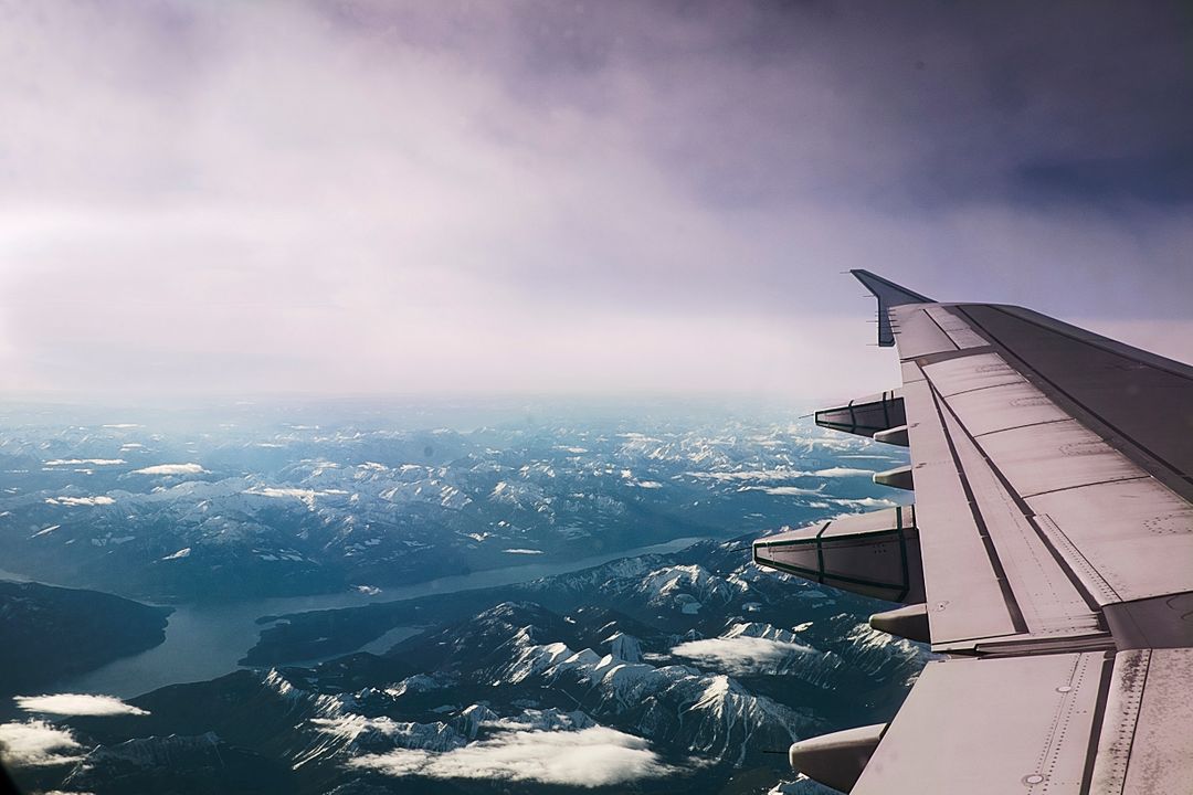 Aerial View of Snowy Mountain Range and Wing of Airplane - Free Images, Stock Photos and Pictures on Pikwizard.com