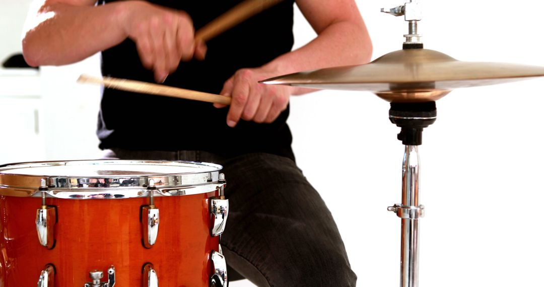 Drummer playing his drum kit on white background - Free Images, Stock Photos and Pictures on Pikwizard.com