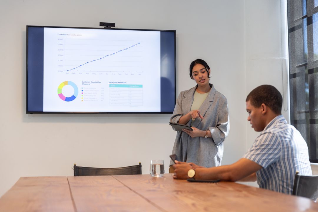 Diverse Colleagues Discussing Analytics in Modern Conference Room