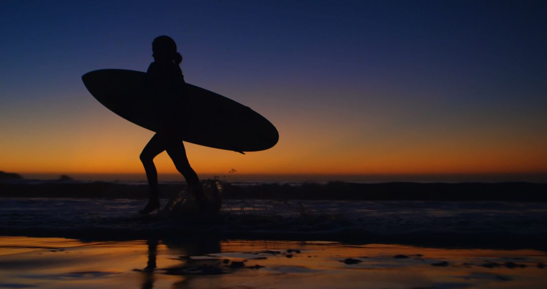 Silhouette of Surfer Walking with Board at Sunset Beach - Free Images, Stock Photos and Pictures on Pikwizard.com