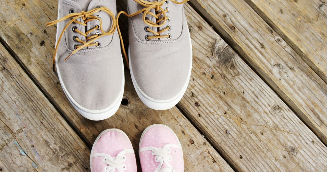 Adult Shoes and Baby Shoes on Wooden Deck - Free Images, Stock Photos and Pictures on Pikwizard.com