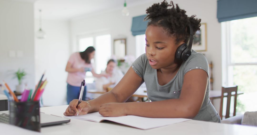 Focused Young Girl Taking Online Classes with Laptop at Home