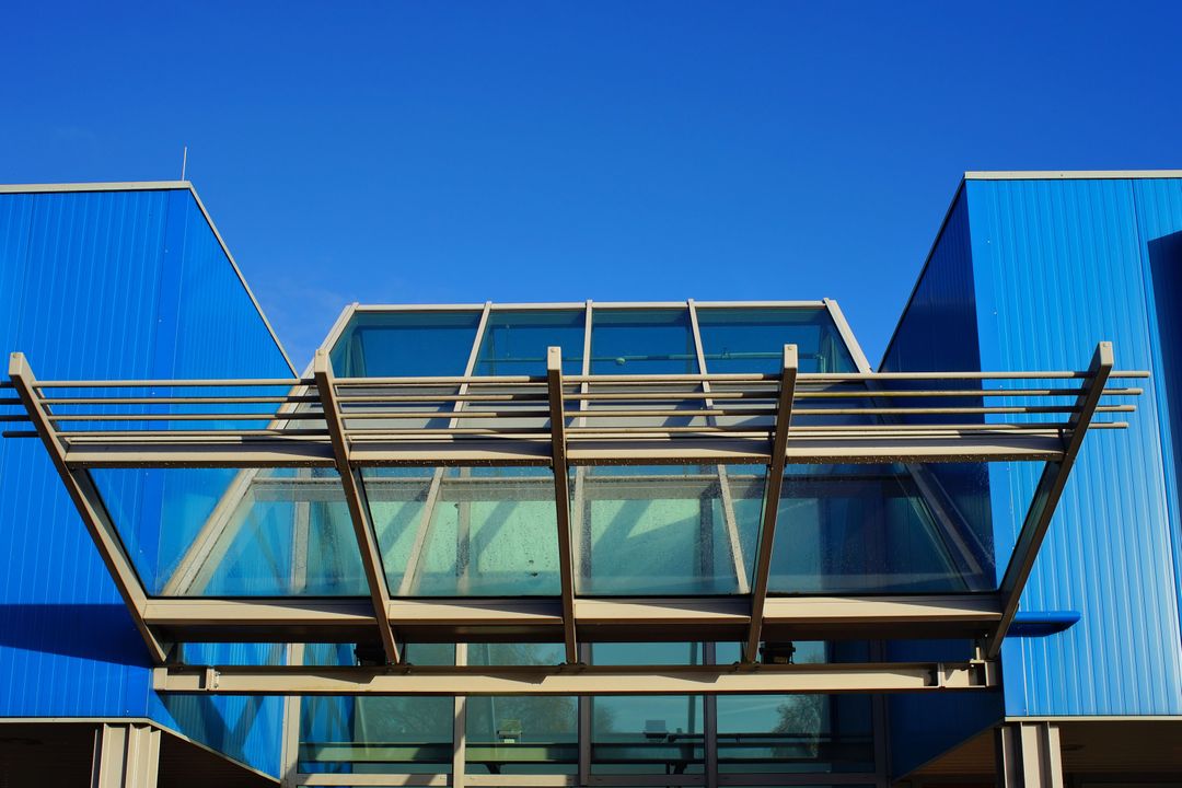 Modern Blue Architectural Building with Glass Canopy - Free Images, Stock Photos and Pictures on Pikwizard.com