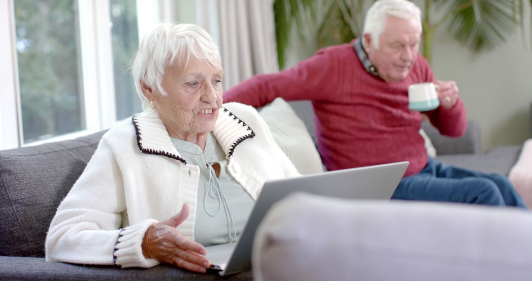 Senior Couple Using Laptop for Video Call at Home